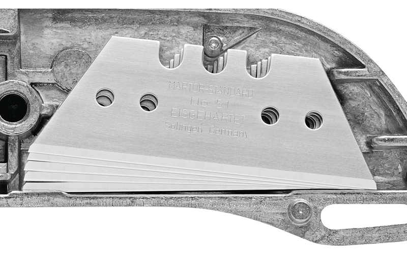 Internal handle storage showing five spare trapezoid blades